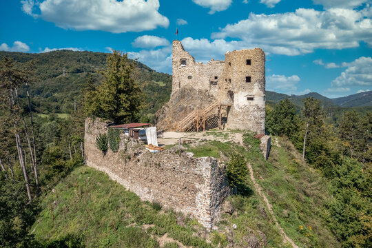 Aerial view of Reviste castle above the Hron river with partially restored gate tower, palace walls and donjon