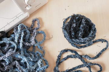 sewing machine and denim yarn, reasonable consumption, second life to old things concept, pre-cut...