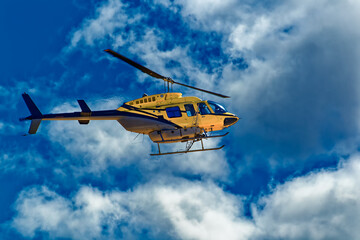Fototapeta na wymiar Side view of crop spraying helicopter and clouds