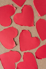 Fototapeta premium torn paper hearts on plain brown paper