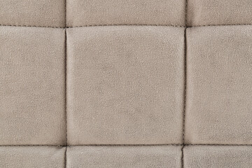 Texture beige fabric. Background of a soft pouf.