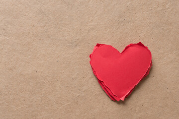 torn paper hearts on plain brown paper