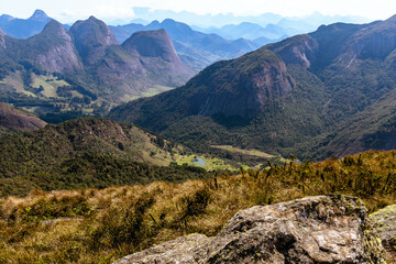 Fototapeta na wymiar Panorama of Vale dos Frades with several peaks for climbing and trekking and Serra dos Orgãos in the background, PNSO, Teresopolis, Rio de Janeiro, Brazil