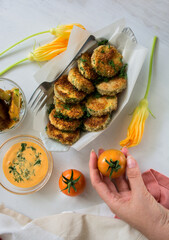 Breaded fried zucchini with tomatoes and sauce. Healthy cooking meal.