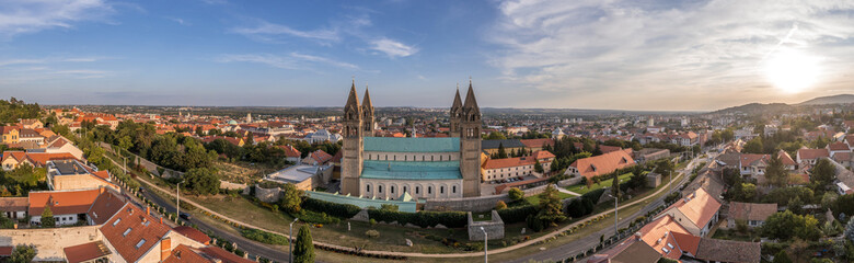 Fototapeta na wymiar Aerial view of Sts. Peter and Paul's Cathedral Basilica, also called Pcs Cathedral, is a religious building of the Catholic church that serves as the cathedral of the Diocese of Pecs with dramatic sky