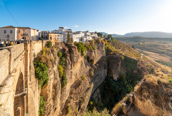 View of the medieval hillside town from one of the cono balconies overlooking the gorge, bridge and canyon valley in Ronda, Spain 