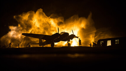 German Junker (Ju-88) night bomber at night. Artwork decoration with scale model of jet-propelled plane in possession. Toned foggy background with light. War scene. - obrazy, fototapety, plakaty