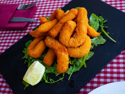 Sepia fried in bread crumbs, served with arugula and lemon. Spanish cuisine