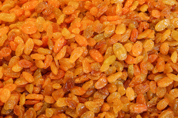 Yellow different types dried raisin fruits background