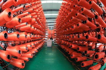 Obraz premium The mechanical equipment of the plastic weaving production line is running in a factory