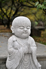 A little monk statue in a Chinese city park