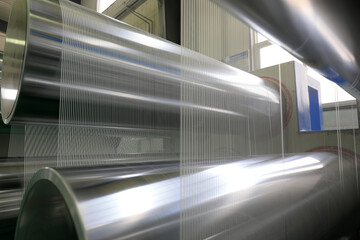 The mechanical equipment of the plastic weaving production line is running in a factory