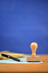 Papers contract and stamp on a desk with blue background