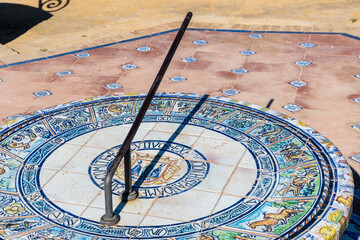 Close up of the decorated ceramic tiled sundial and seat in Parque de Maria Luisa, Seville, Spain.