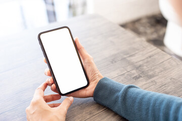 cell phone blank white screen mockup.hand holding texting using mobile on desk at office.background empty space for advertise.work people contact marketing business,technology