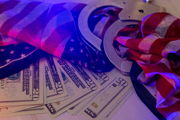 Red light flasher police of handcuffs on American dollar bills