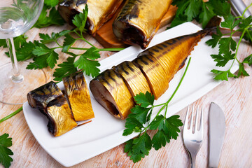 Image of sliced smoked mackerel fish served with greens, nobody