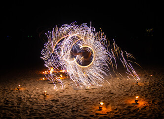 Fire show on the beach at night in Phuket, Thailand