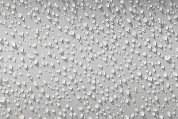 Water droplets on a white background with shadows from the light shining down on them.