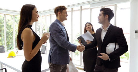 businessmen and Engineer group using notebook for business partners discussing documents and ideas at meeting and business women smiling happy for working