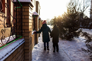 children's winter walk around the city on a frosty day at sunset.