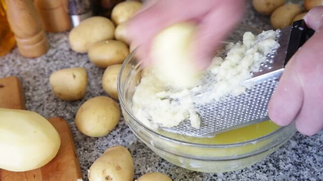 Closeup of Cooking otato pancakes draniki on grater . High quality FullHD footage