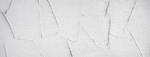 荒いこて跡のある白い壁の背景テクスチャー