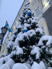 decorated street christmas tree in the snow