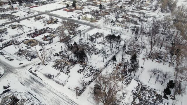 Drone Aerial View Of Burned Down Superior Colorado Neighborhood Covered In Snow After Marshall Fire Wildfire Disaster.