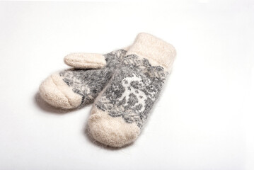 Warm fluffy wool mittens on a white background.