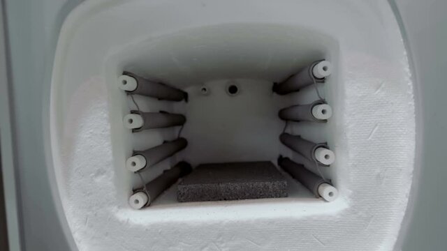 Muffle furnace - a heating device designed to heat various parts and materials to the required temperature and heat treatment (firing). Shot in motion. Closeup