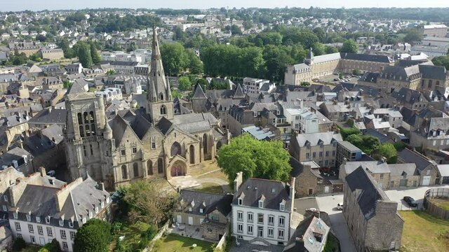 General view of French town of Guingamp in summer looking out over medieval Basilica and walls of ancient fortified chateau, Brittany