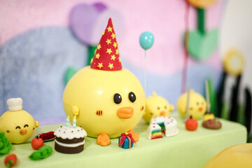 Fototapeta na wymiar Funny yellow ducks decorated cakes for a baby shower birthday