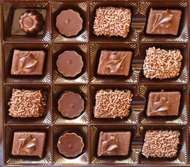 Box of different chocolate sweets close up