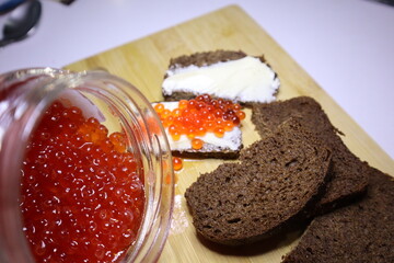 Red caviar from a jar. Sandwiches with red caviar