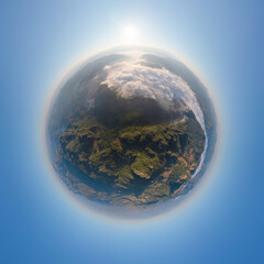 Little planet 360 degree sphere. Panorama of aerial top view of forest trees and green mountain hills with sea fog, mist and clouds. Nature landscape background, Thailand.