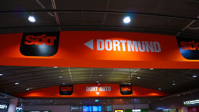 Dortmund, Germany - December 28, 2021: Sixt car rental employee waits for customers at Dortmund Airport