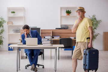 Old boss and young male employee in summer vacation concept