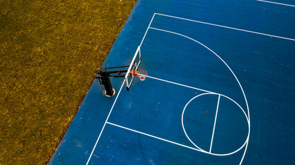 vibrant blue basketball hoop in autumn