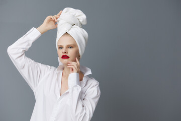 woman with a towel on his head in a white shirt isolated background