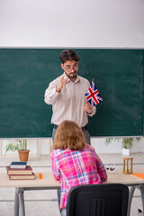 Young male english language teacher and redhead girl in the clas