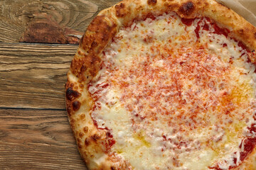 Pizza Margherita on wooden background, top view. Flyer and poster for Restaurants or pizzerias, template with delicious taste margarita pizza, mozzarella cheese