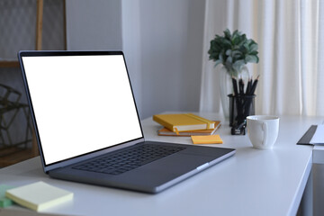 Fototapeta na wymiar Computer laptop with empty display on white office desk.