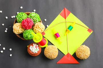 Fototapeta Indian festival makar sankranti concept, Colorful kite ,string and sweet sesame seed ball. obraz