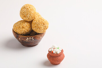Indian sweet for traditional festival makar sankranti :Rajgira laddu made from Amaranth seed in Bowl on white background.
