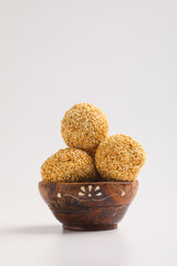 Indian sweet for traditional festival makar sankranti :Rajgira laddu made from Amaranth seed in Bowl on white background.