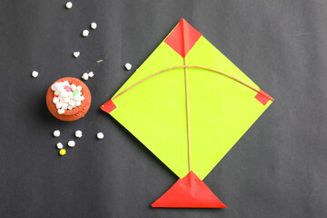 Indian festival makar sankranti concept, Colorful kite ,string and sweet sesame seed ball.