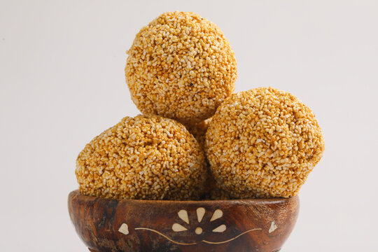 Indian sweet for traditional festival makar sankranti :Rajgira laddu made from Amaranth seed in Bowl on white background.