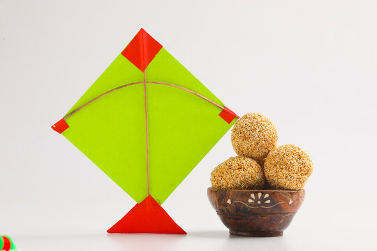 Indian festival makar sankranti concept, Colorful kite ,string and sweet sesame seed ball.