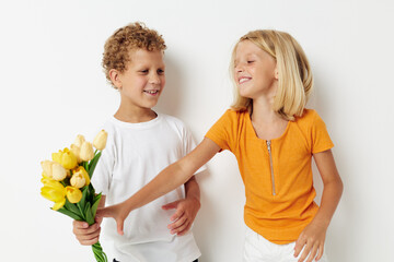 Fototapeta na wymiar Cute stylish kids with a bouquet of flowers gift birthday holiday childhood light background